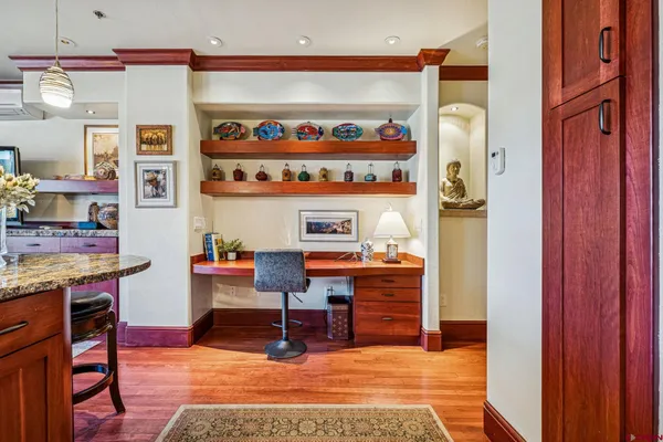 a view of kitchen with stainless steel appliances dining table and chairs