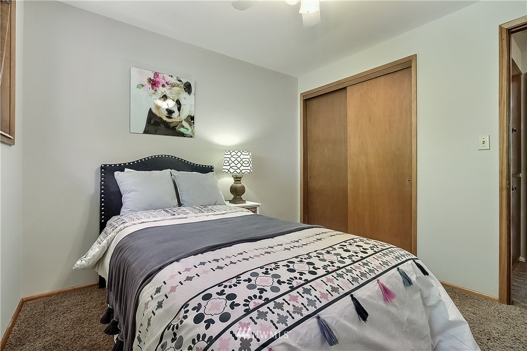 4032 Southwest Myrtle Street Seattle, WA 98136 - Photo 14 of 23 a bedroom with a bed and painting on the wall