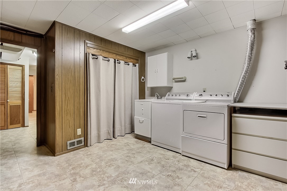 4032 Southwest Myrtle Street Seattle, WA 98136 - Photo 20 of 23 a utility room with cabinets washer and dryer
