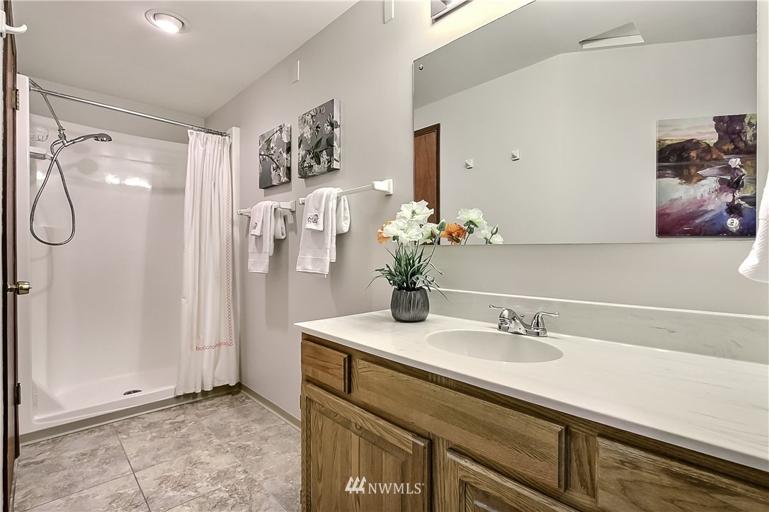4032 Southwest Myrtle Street Seattle, WA 98136 - Photo 21 of 23 a bathroom with a sink vanity and a mirror