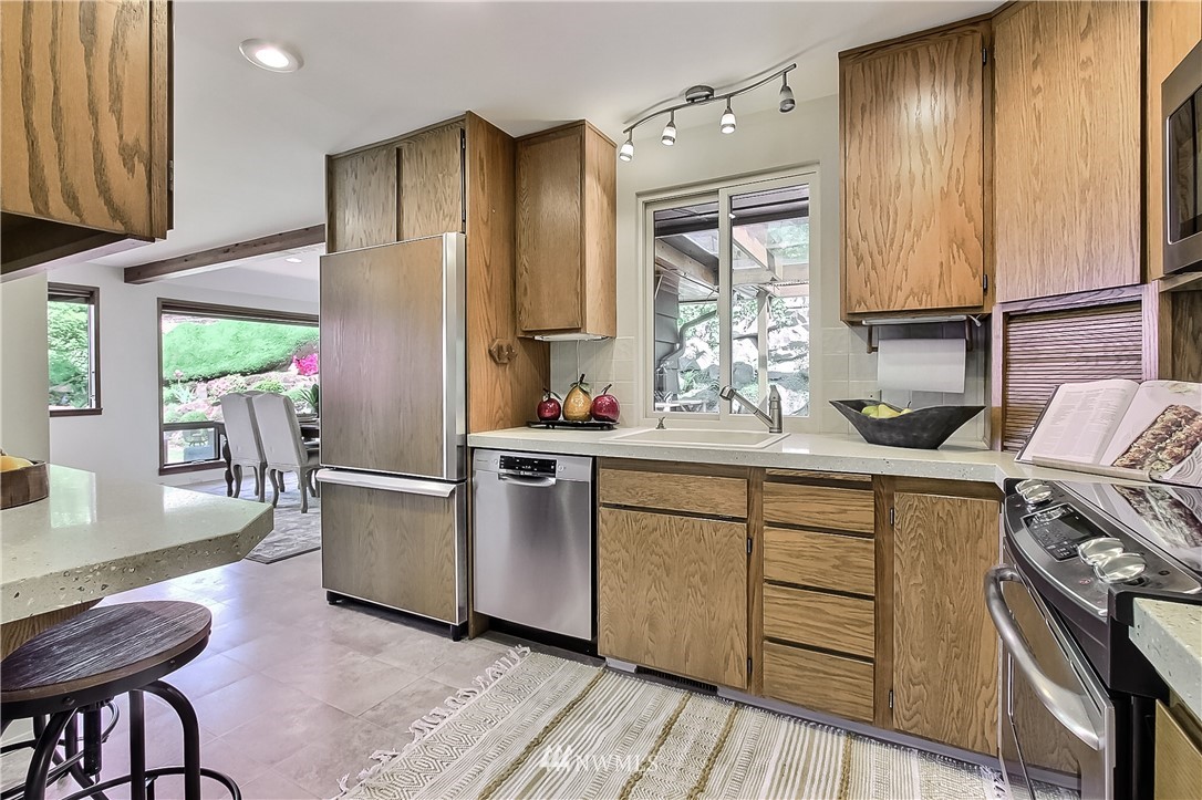 4032 Southwest Myrtle Street Seattle, WA 98136 - Photo 9 of 23 a kitchen with stainless steel appliances a sink stove and wooden floor