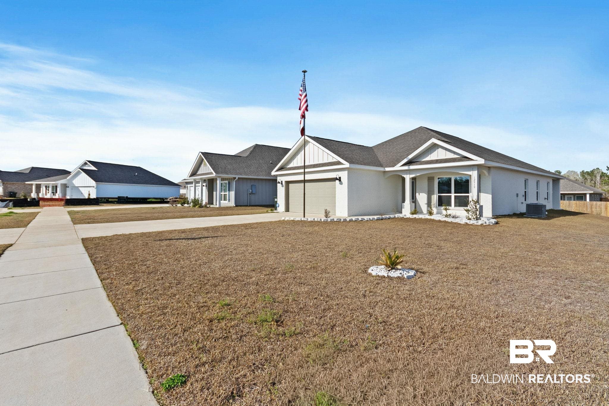 12919 Torrent Road Fairhope, AL 36532 - Photo 6 of 74 View of front facade featuring concrete driveway and a garage