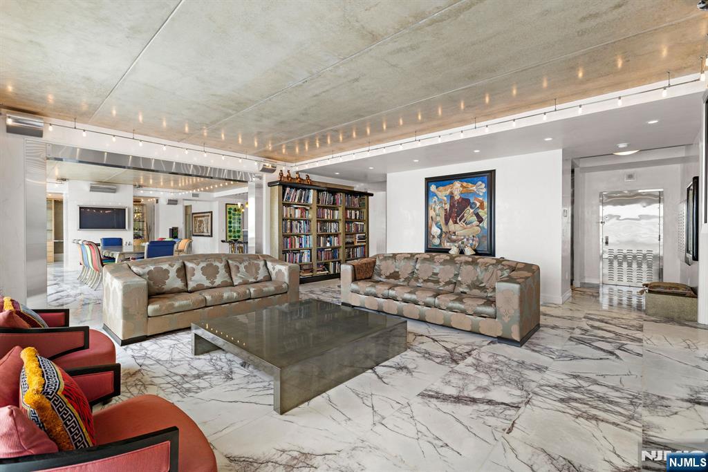 1055 River Road, Unit PH 8 Edgewater, NJ 07020 - Photo 12 of 30 a living room with furniture and wooden floor