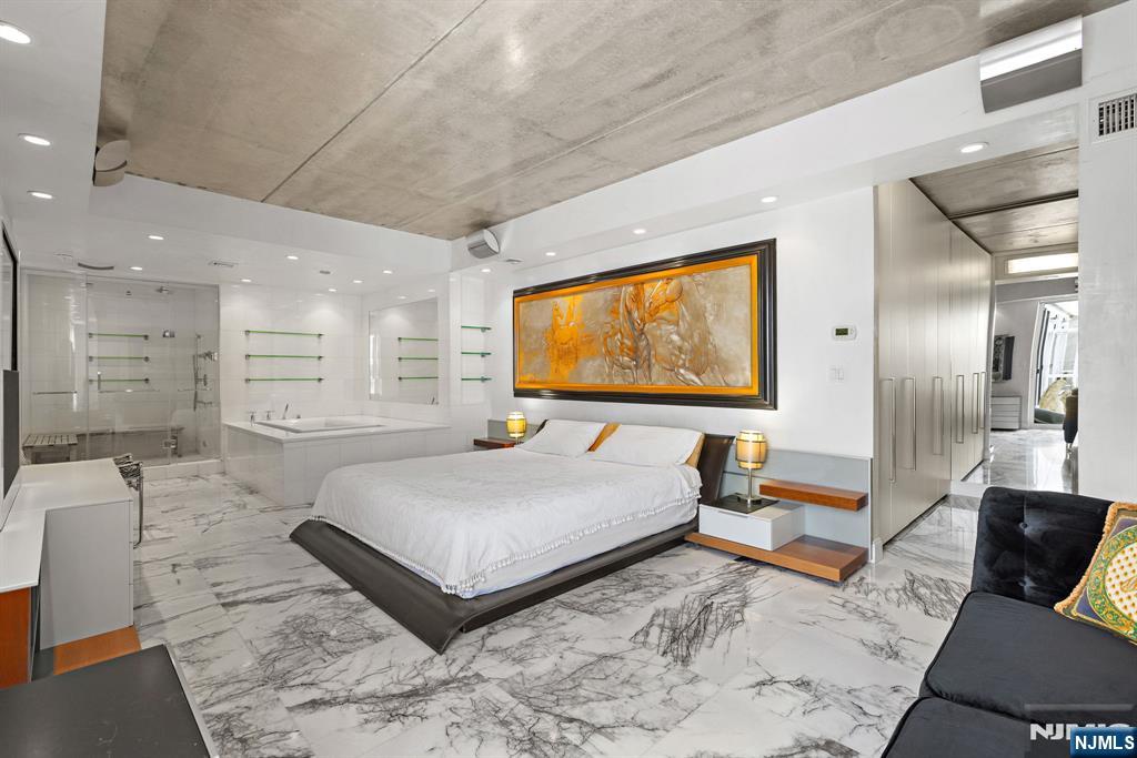 1055 River Road, Unit PH 8 Edgewater, NJ 07020 - Photo 14 of 30 a living room with furniture and a flat screen tv