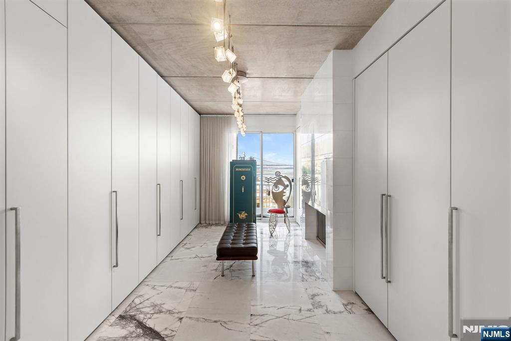 1055 River Road, Unit PH 8 Edgewater, NJ 07020 - Photo 17 of 30 a view of a hallway with wooden floor and a living room