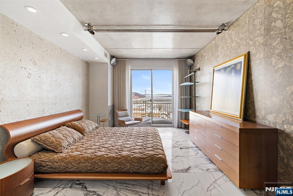 1055 River Road, Unit PH 8 Edgewater, NJ 07020 - Photo 18 of 30 a bedroom with a large bed and a window