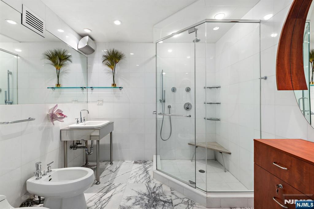 1055 River Road, Unit PH 8 Edgewater, NJ 07020 - Photo 19 of 30 a bathroom with a sink toilet and shower