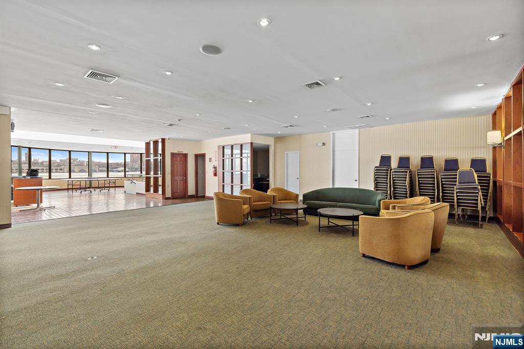 1055 River Road, Unit PH 8 Edgewater, NJ 07020 - Photo 27 of 30 a living room with furniture and a flat screen tv