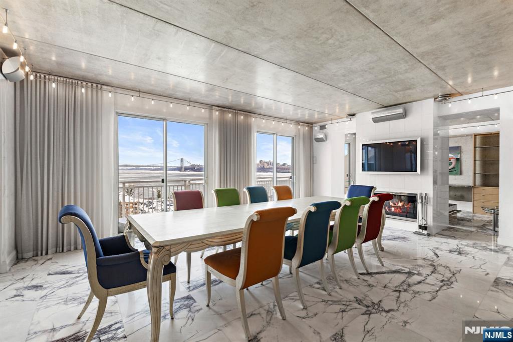 1055 River Road, Unit PH 8 Edgewater, NJ 07020 - Photo 5 of 30 a view of a dining room with furniture window and outside view