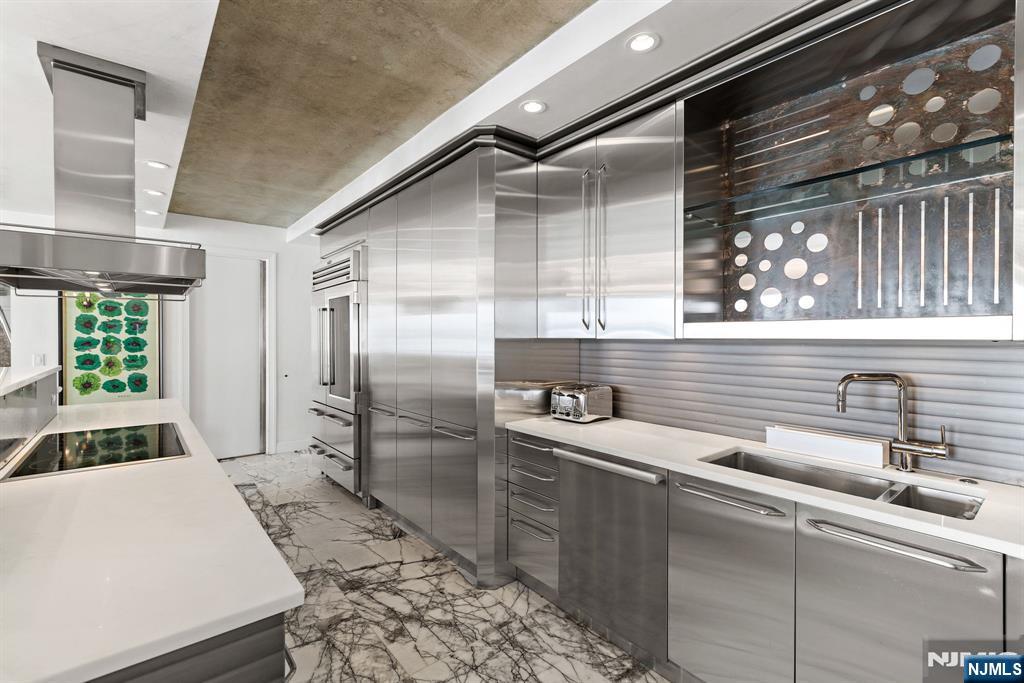 1055 River Road, Unit PH 8 Edgewater, NJ 07020 - Photo 7 of 30 a kitchen with a sink and refrigerator