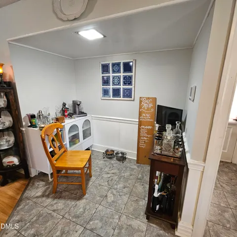 a living room with furniture a flat screen tv and next to a window