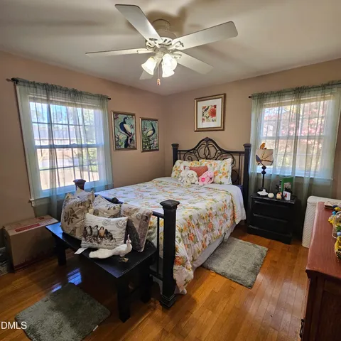 a bedroom with bed window and couch