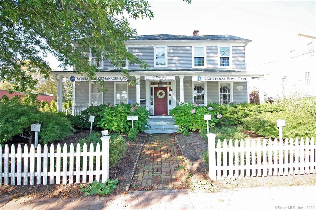 129 Main Street Old Saybrook, CT 06475 - Photo 1 of 1 a front view of a house with a garden