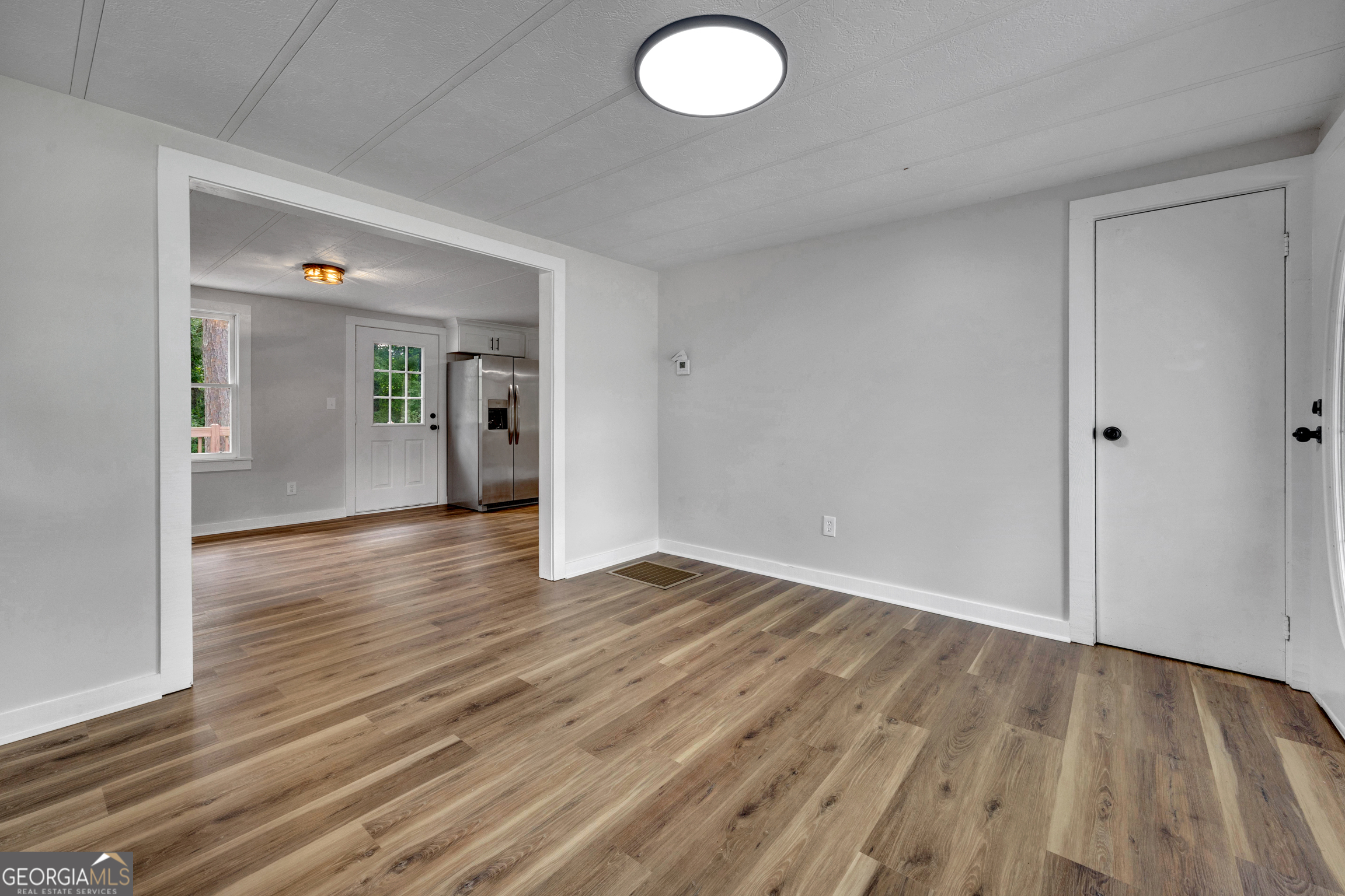 455 Cindy Street Jackson, GA 30233 - Photo 5 of 25 a view of an empty room and wooden floor