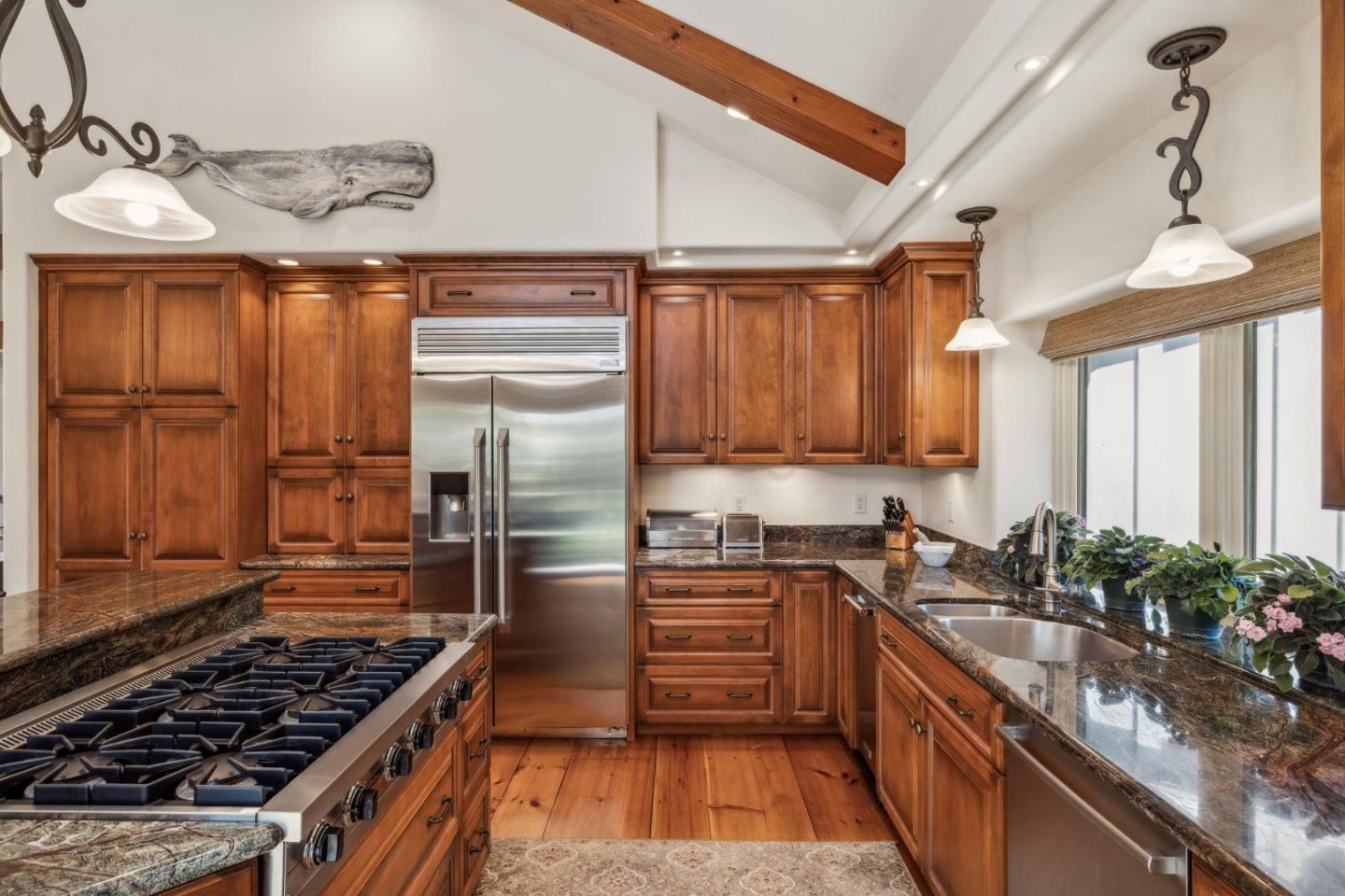 9546 Maple Court Carmel, CA 93923 - Photo 17 of 36 a kitchen with kitchen island granite countertop a sink stainless steel appliances and cabinets