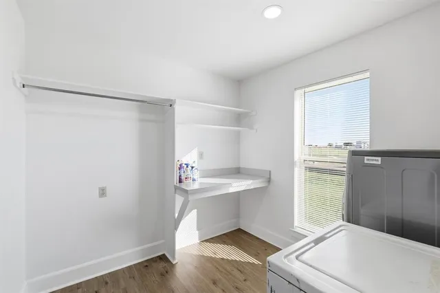 a room with a white bed and a window