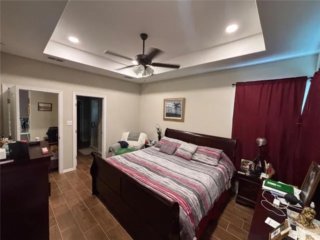 a bedroom with a bed and a chandelier