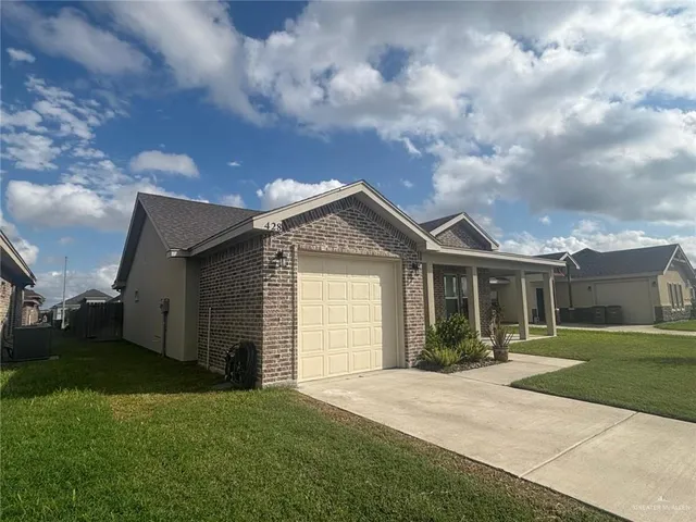 a front view of house with yard and green space