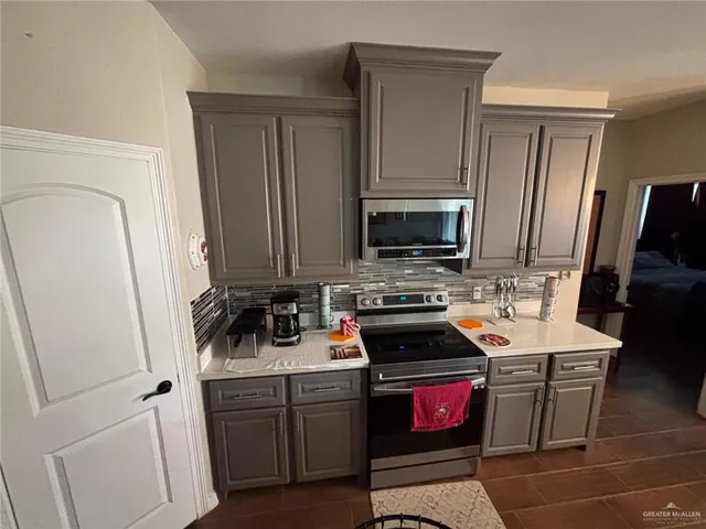 a kitchen with a sink stove and refrigerator