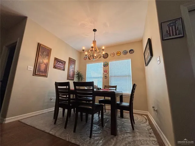 a view of a dining room with furniture and chandelier