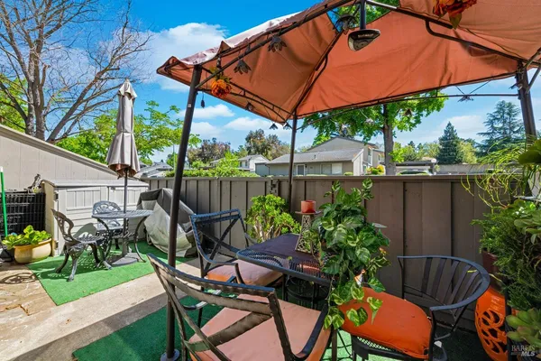 a patio with a patio table and chairs