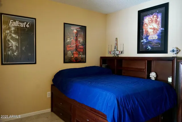 a bedroom with a bed and a dresser