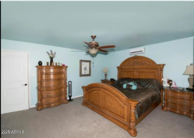 a bedroom with bed and a chandelier