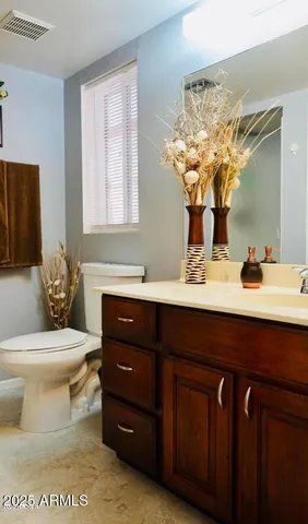 a bathroom with a sink toilet and mirror