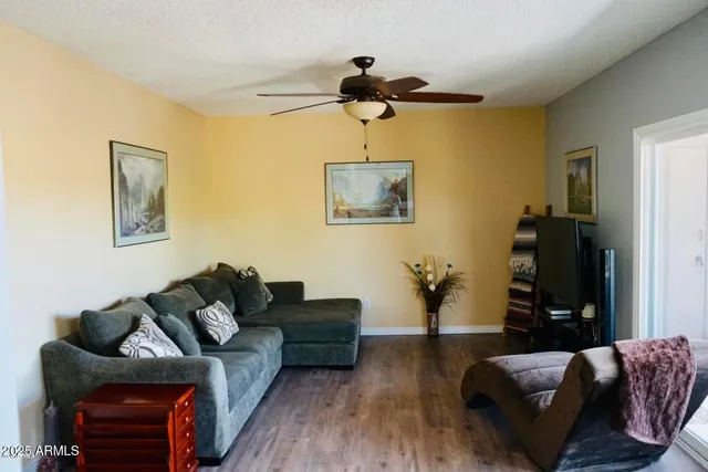 a living room with furniture and wooden floor
