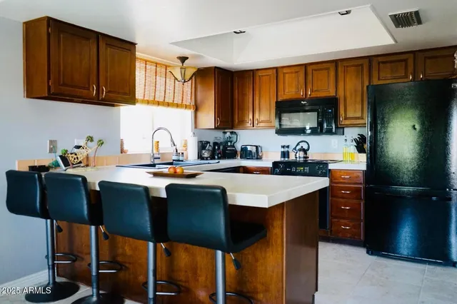 a kitchen with a sink refrigerator and cabinets