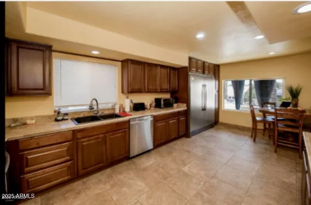 a kitchen with stainless steel appliances granite countertop a sink and cabinets