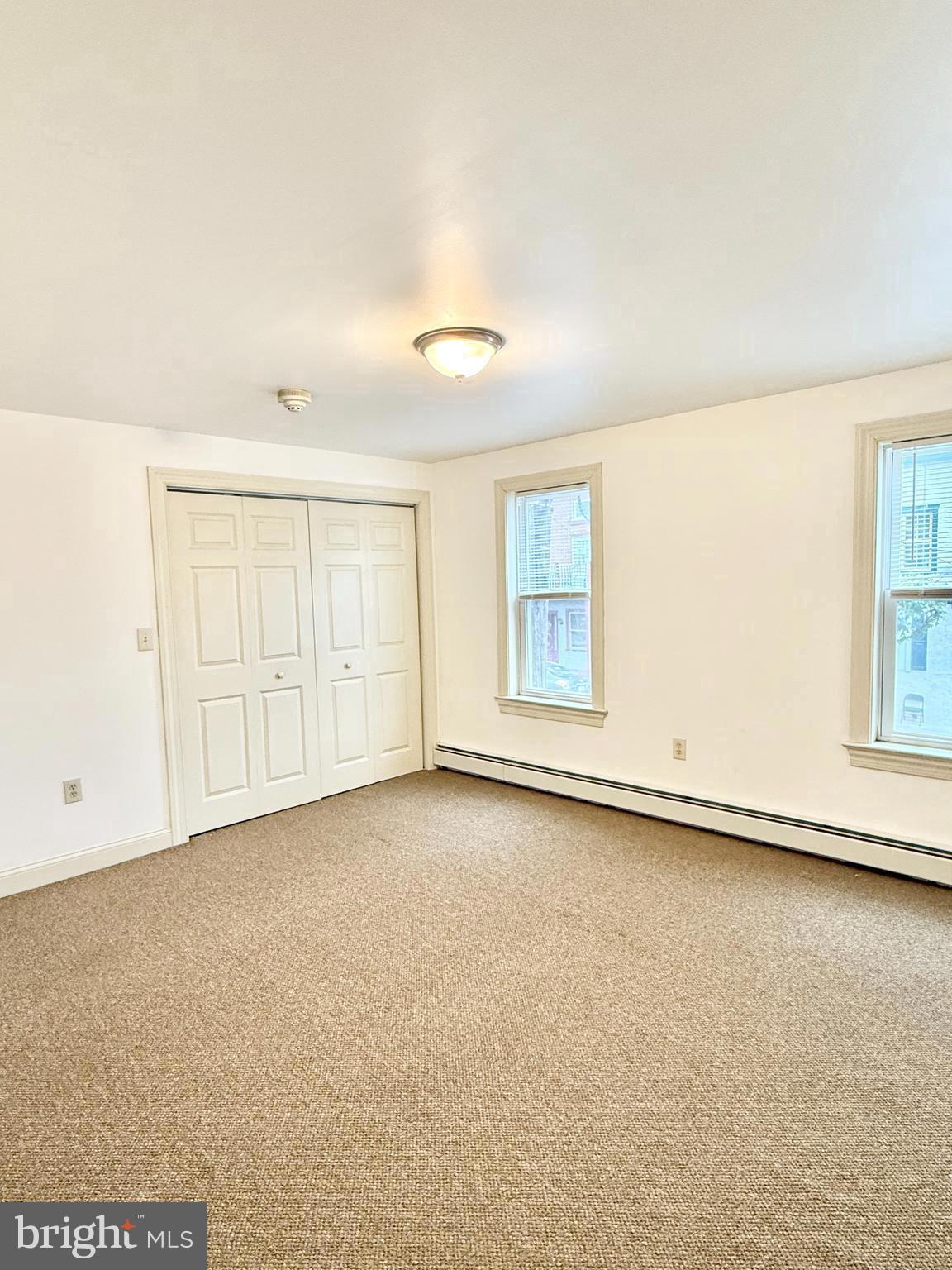 26 North Main Street Spring City, PA 19475 - Photo 8 of 12 an empty room with a empty space and windows