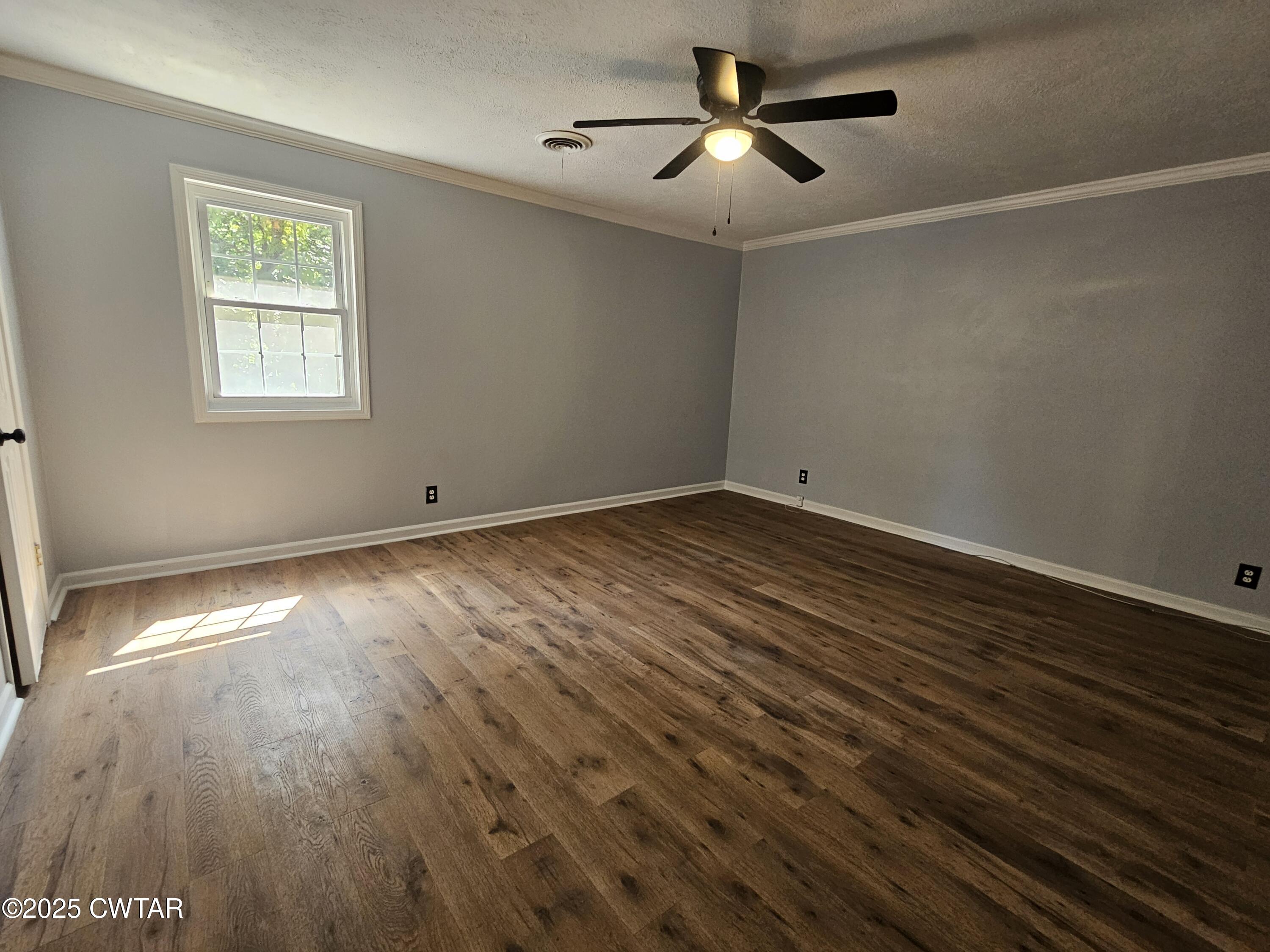 116 Chickering Road Jackson, TN 38305 - Photo 12 of 20 a view of empty room with wooden floor and fan