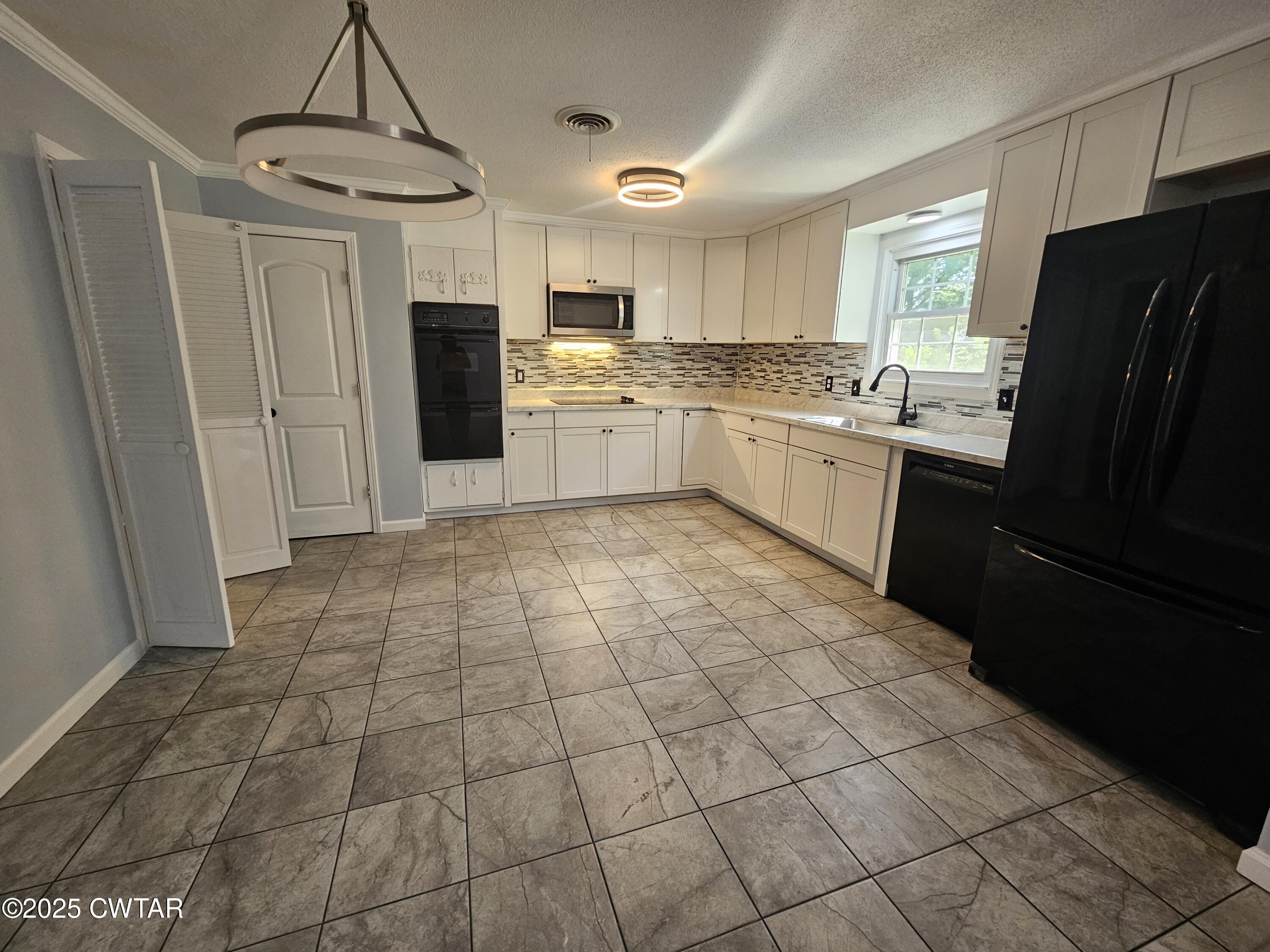 116 Chickering Road Jackson, TN 38305 - Photo 6 of 20 a kitchen with stainless steel appliances granite countertop a refrigerator and a sink
