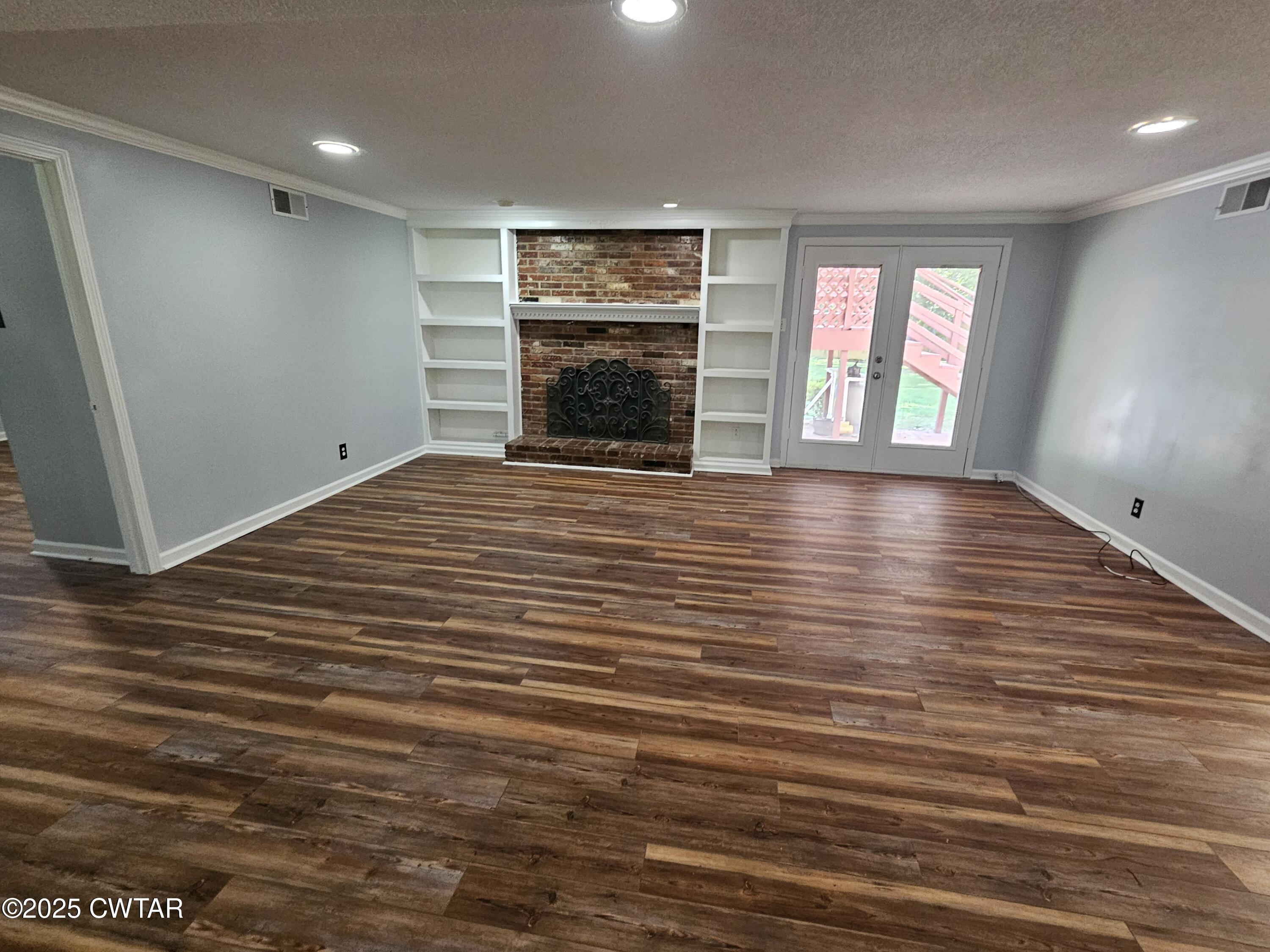 116 Chickering Road Jackson, TN 38305 - Photo 8 of 20 an empty room with windows and fireplace