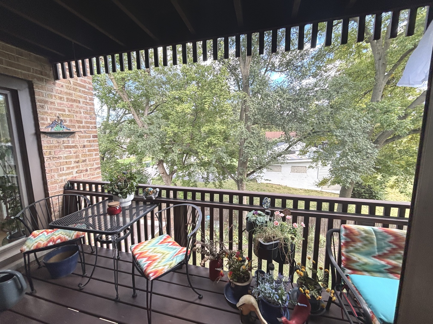 1847 Tanglewood Drive, Unit 3B Glenview, IL 60025 - Photo 16 of 30 a balcony with wooden floor and outdoor seating