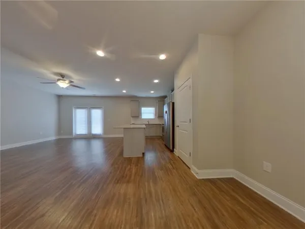 a view of empty room with wooden floor