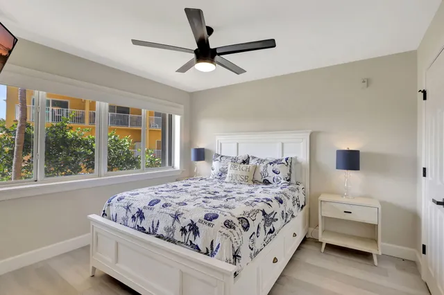 a bathroom with a granite countertop sink toilet mirror and shower