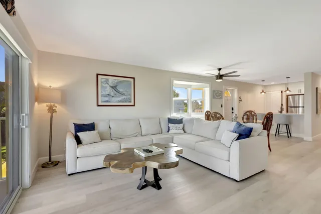 a kitchen with kitchen island white cabinets and stainless steel appliances