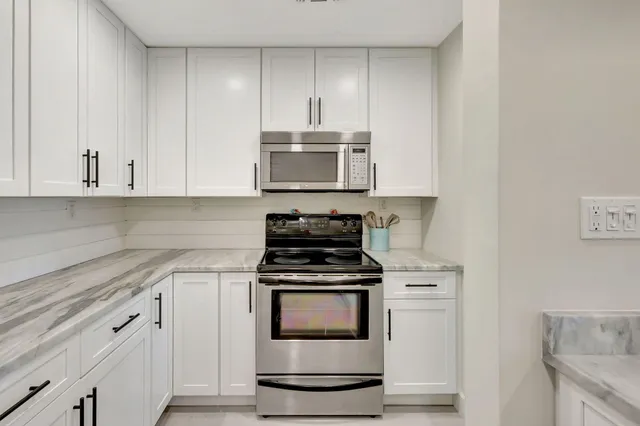 a kitchen with a sink and a refrigerator