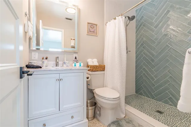 a bathroom with a sink toilet and shower