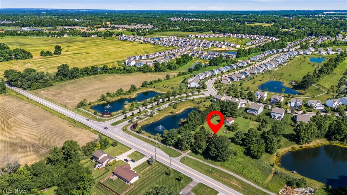6890 Refugee Road Pickerington, OH 43147 - Photo 47 of 49 Aerial perspective showcasing the property's setting amidst residential developments, open fields, and various water features