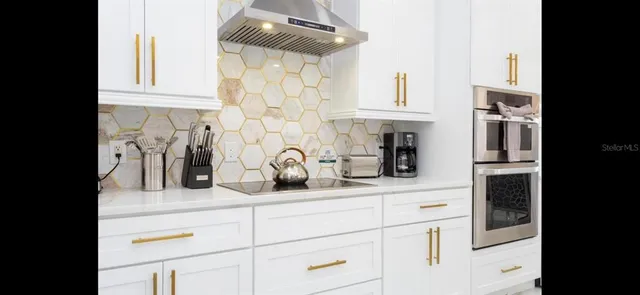 a kitchen with stainless steel appliances granite countertop a sink and cabinets