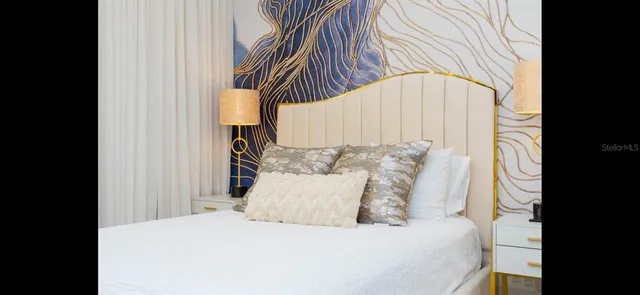 a bedroom with a bed and a mirror