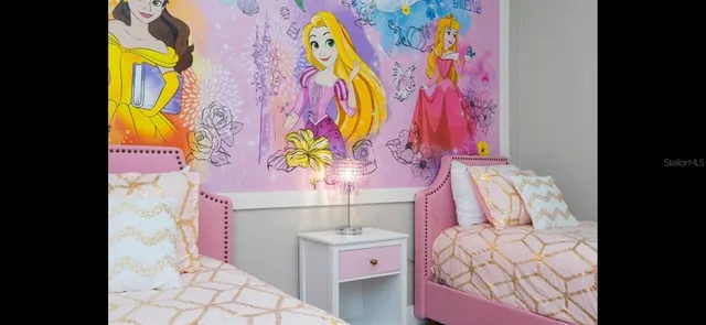 a bathroom with a granite countertop sink and a toilet