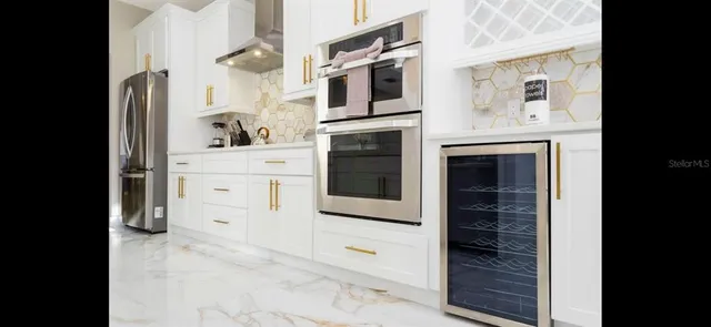 a view of a dining room with furniture and a potted plant