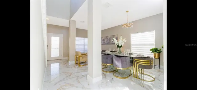 a view of open kitchen with dining table and chairs