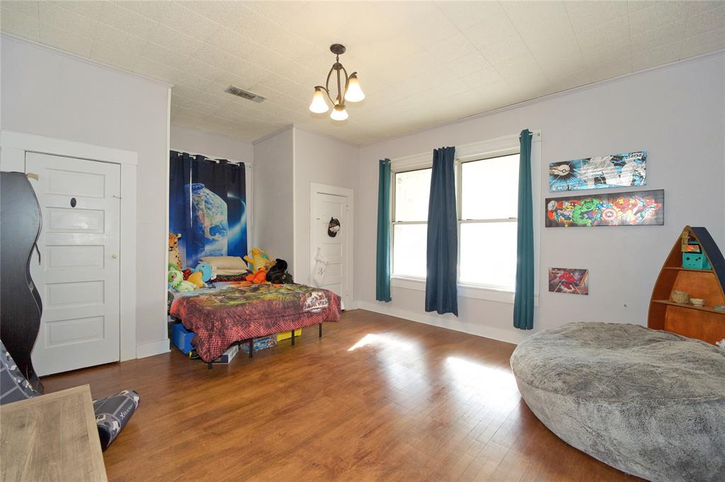 213 South Clements Street Gainesville, TX 76240 - Photo 17 of 37 a bedroom with bed and window
