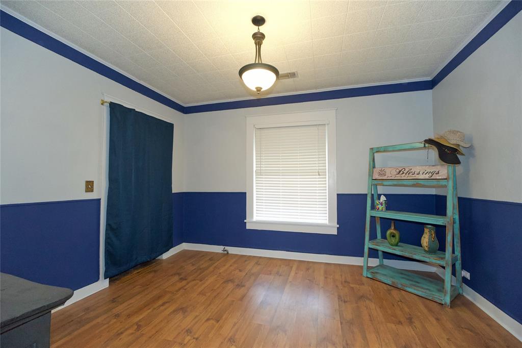 213 South Clements Street Gainesville, TX 76240 - Photo 18 of 37 a bedroom with furniture and a window