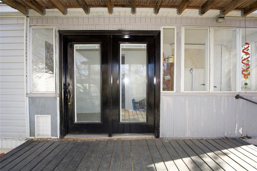 213 South Clements Street Gainesville, TX 76240 - Photo 28 of 37 a view of a wooden door with a glass door